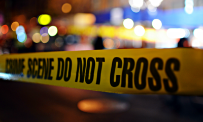 photo of crime scene tape and lights at night