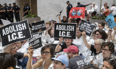 AP photo of activists carrying "Abolish I.C.E." signs