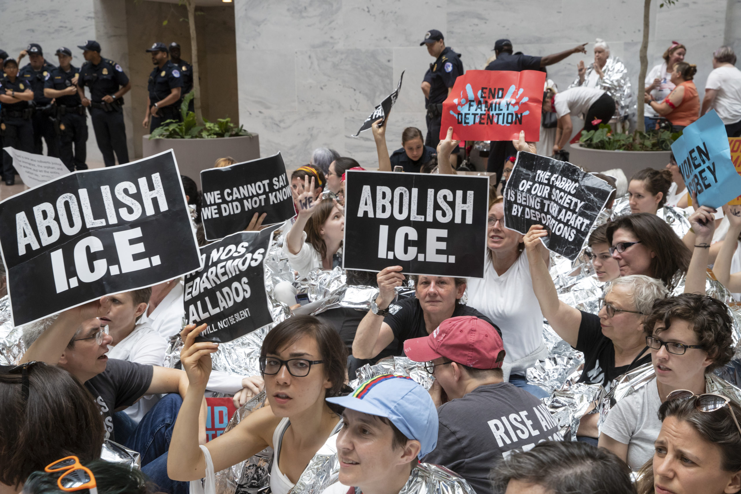 AP photo of activists carrying "Abolish I.C.E." signs