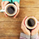 Shutterstock photo of two female hands holding cups of coffee