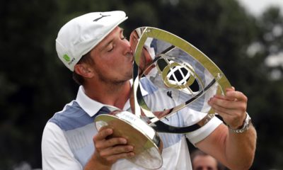 Photo of Bryson DeChambeau kissing the trophy after winning the Northern Trust golf tournament