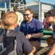 Photo of two students sitting outside with a teacher at CTEC