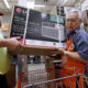 Picture of a man buying a room air conditioner in Seattle.