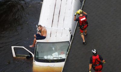 Photo of rescue team saving a man from flooding during Hurricane Florence