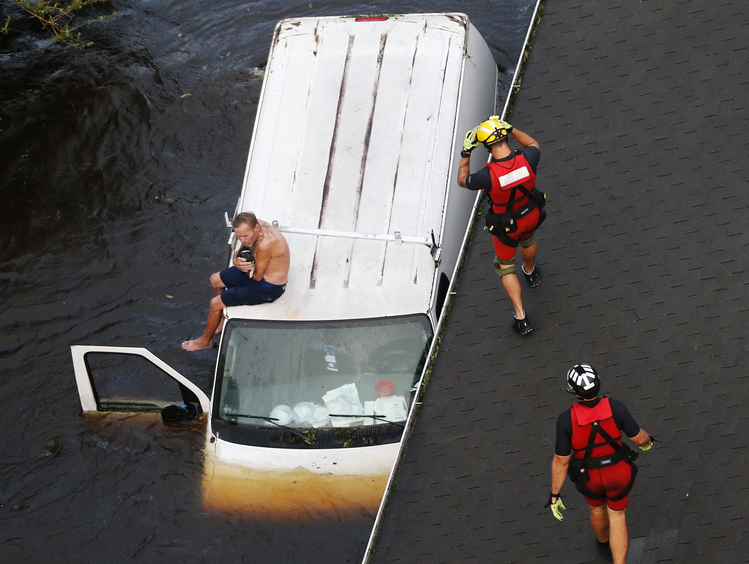 Photo of rescue team saving a man from flooding during Hurricane Florence