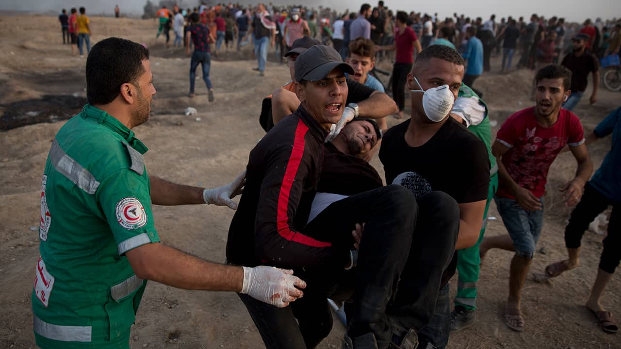 Photo of Palestinians evacuating a wounded protester