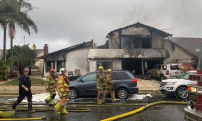 Photo of plane crash scene and firefighters