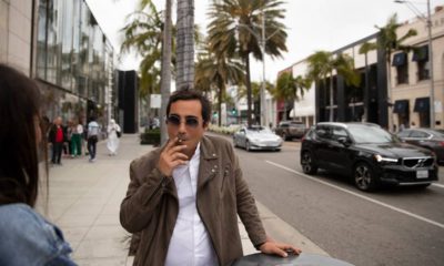 Photo of of man smoking in front of luxury shops in Beverly Hills