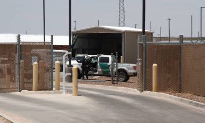 Photo of an officer guarding the entrance to the Border Patrol station in Clint, Tx.