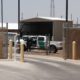 Photo of an officer guarding the entrance to the Border Patrol station in Clint, Tx.