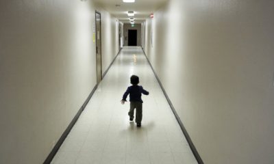 Photo of a child running down a hallway