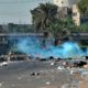 Photo of Iraqi security forces using tear gas