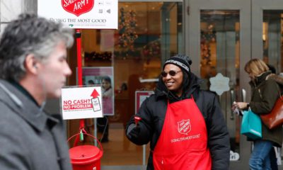 Photo of bell ringer Carolyn Harper encouraging people to donate