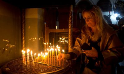 Photo of a visitor lighting candles