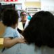 Photo of a family standing in line at a pharmacy