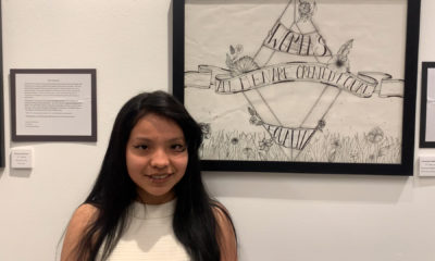 Photo of a Hoover High student in front of her artwork at M Street Street Arts Complex