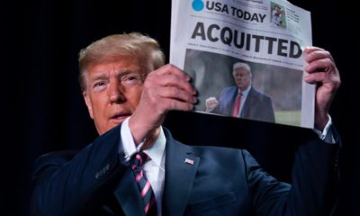 Photo of President Donald Trump holding up a newspaper that read "ACQUITTED"