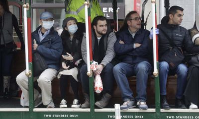 San Francisco cable car riders wearing masks.