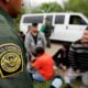 Photo of a border patrol agent talk to a group of people